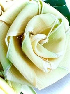 Palm frond cross with roses for Christian sympathy and bereavement décor