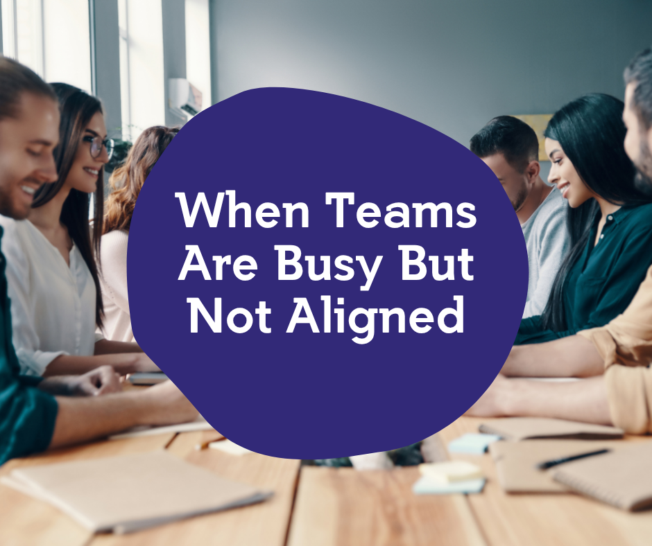 Group of diverse people sitting around a conference table, smiling and engaged in a meeting, with text overlay saying 'When Teams Are Busy But Not Aligned'.