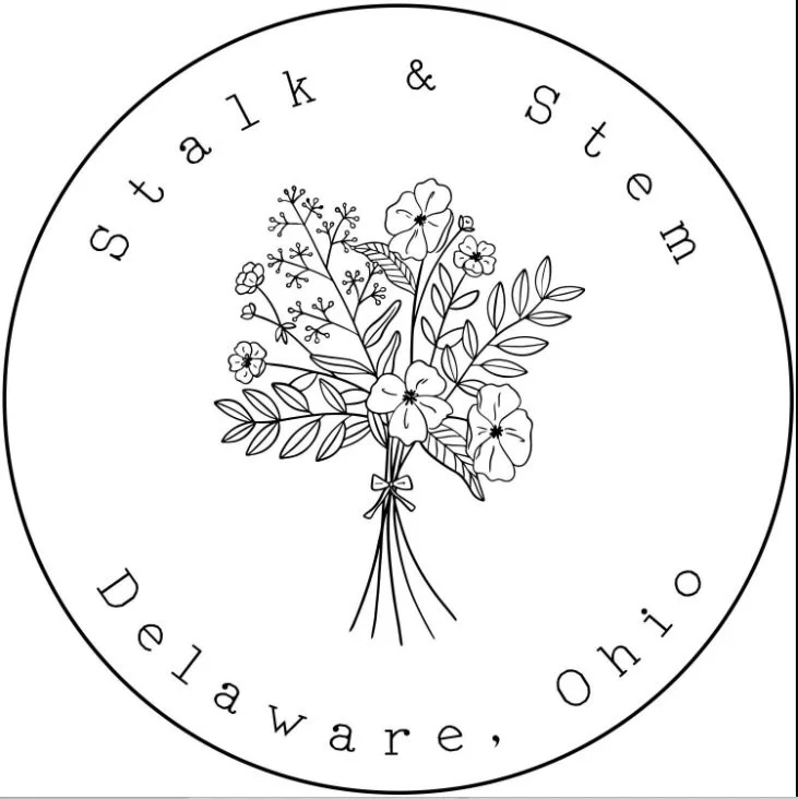A circular logo with a bouquet of flowers in the center, surrounded by the text 'statik & stem' at the top and 'Delaware, Ohio' at the bottom.