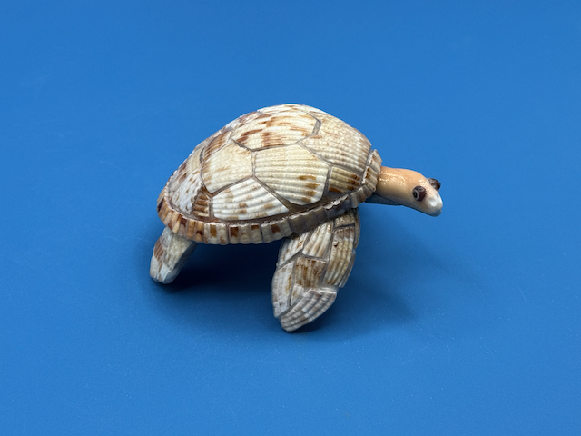 Handcrafted small sea turtle sculpture made from natural ocean materials