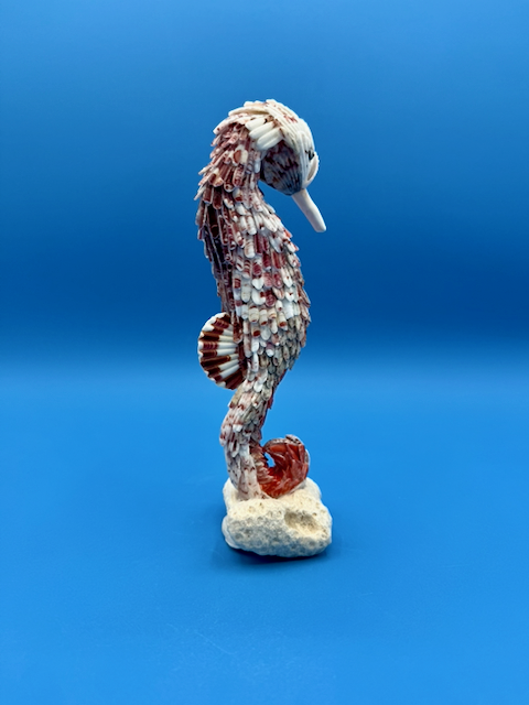 Full view of the shell seahorse sculpture highlighting its curved tail, natural shell patterns, and coastal design.