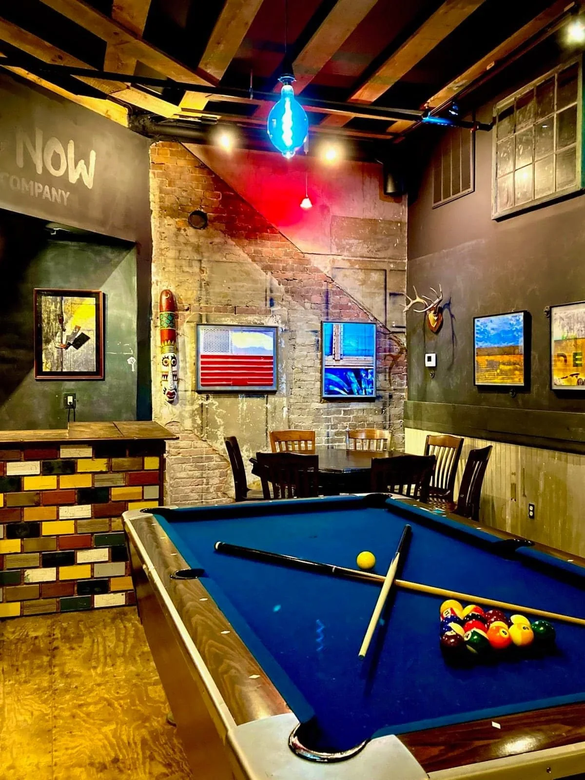 A picture of the private dining room in honesdale pa at here and now brewing. There is a pool table in the center of the room.