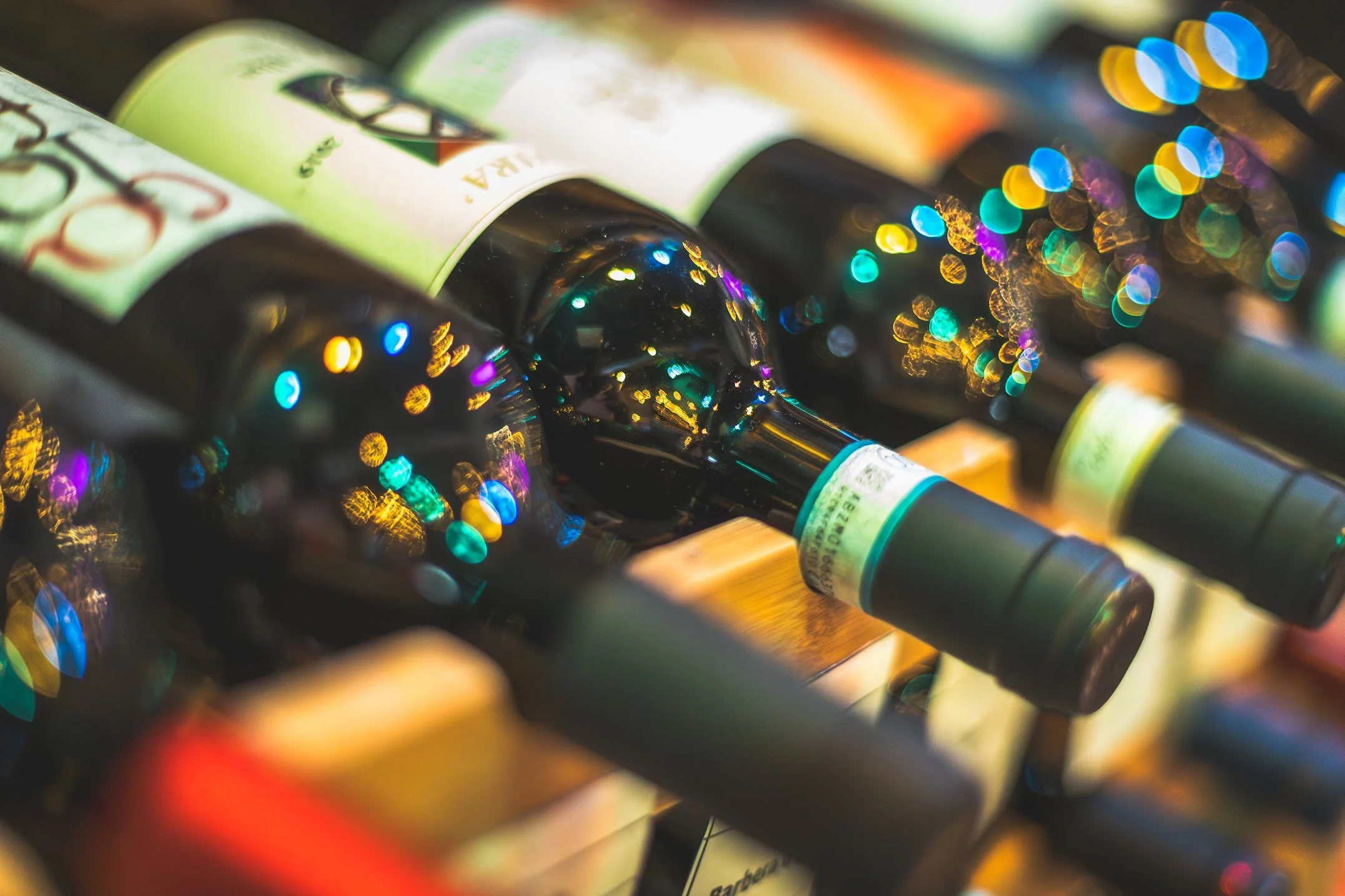 An artistic photo of a selection of Italian wine that is available in house or to-go.