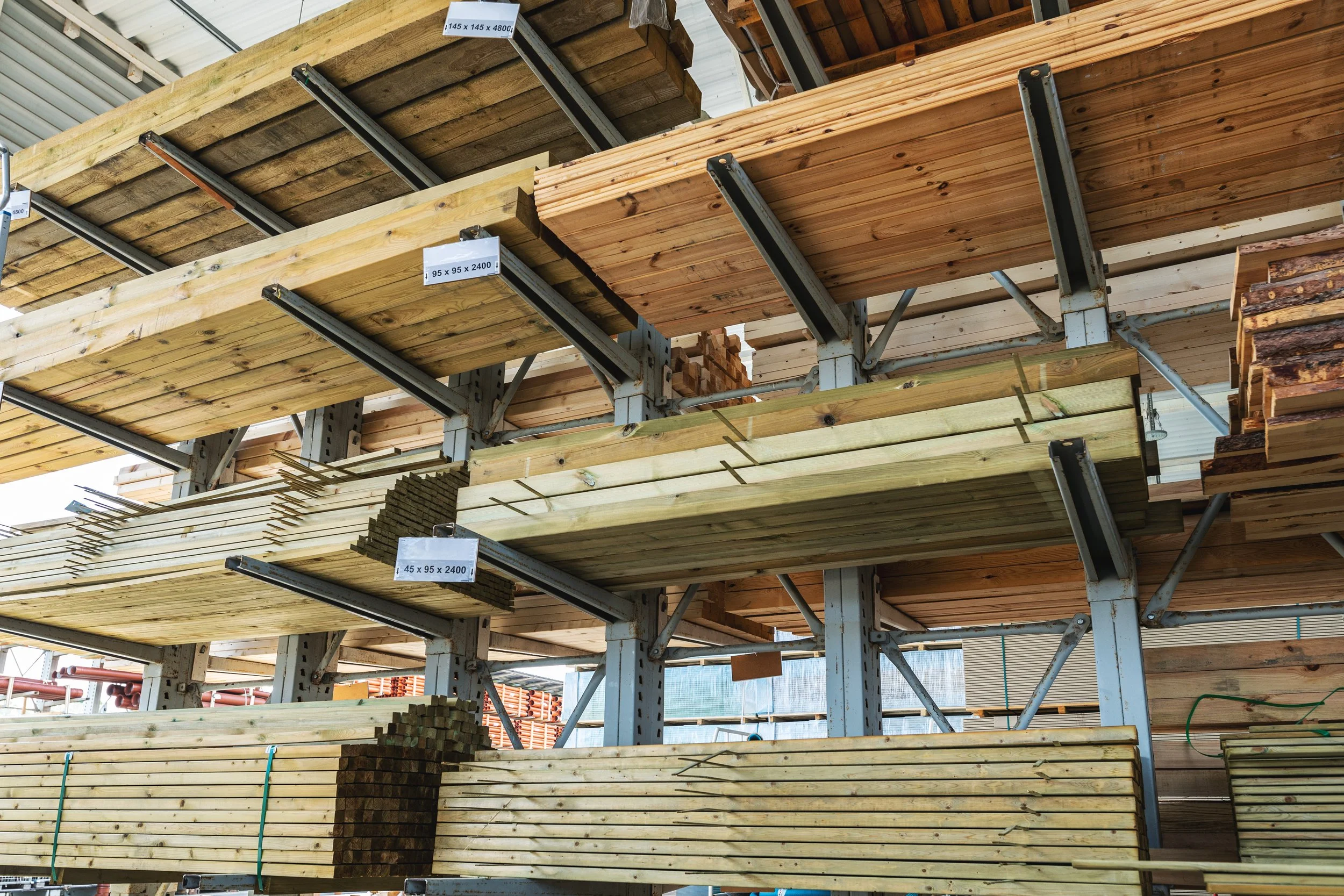 Shelves with different types of lumber wood stored in a hardware store