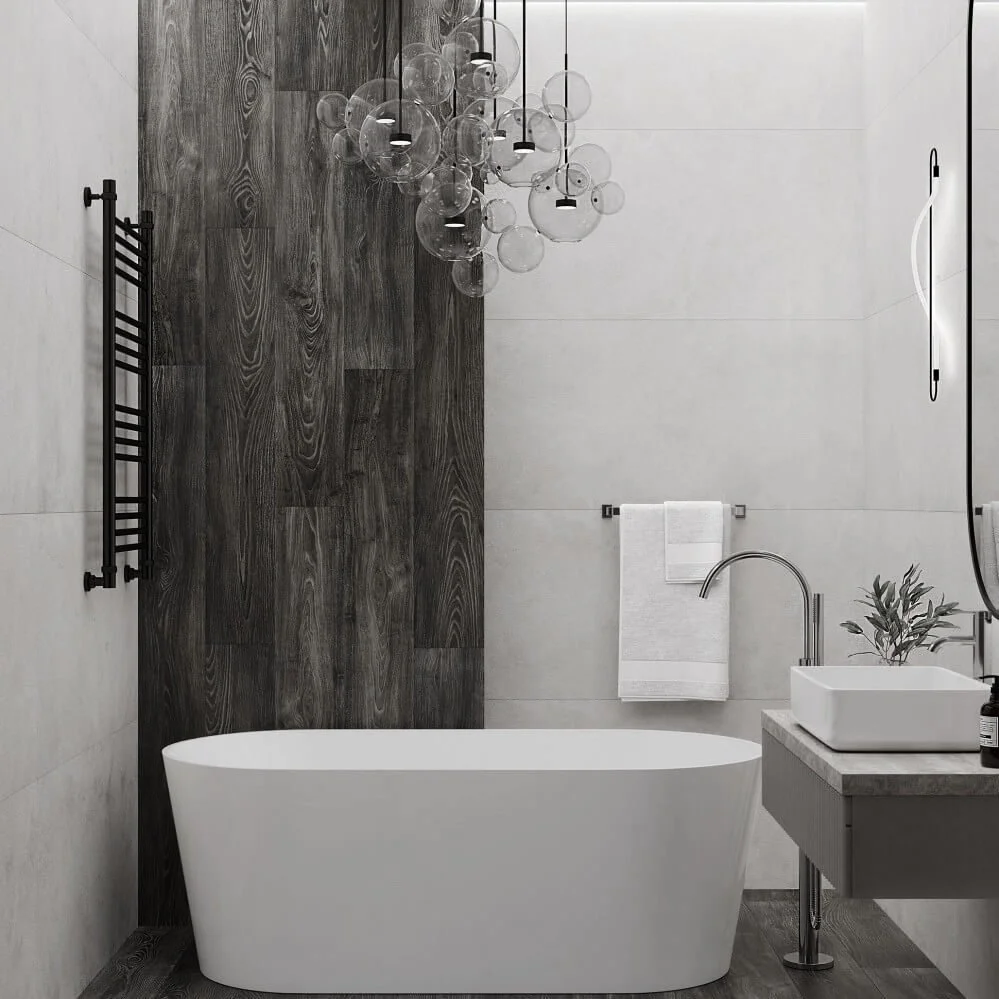 Modern bathroom with a white bathtub, wooden accent wall, black towel rack, and contemporary lighting fixture with hanging glass globes.