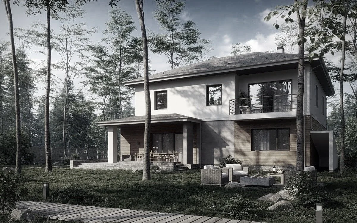 A modern two-story house with a balcony and patio, surrounded by tall trees and a well-maintained yard with outdoor furniture and a wooden pathway.
