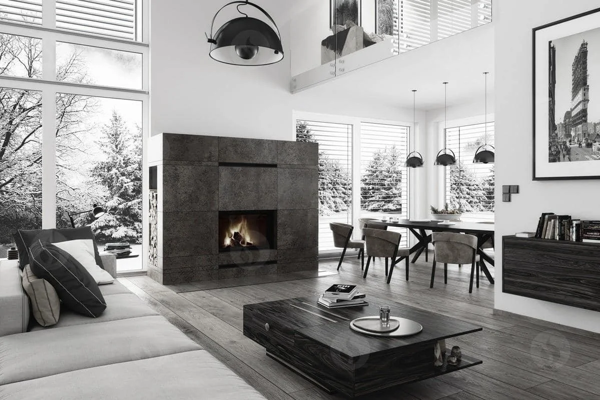 A modern living room with a fireplace, large windows showing snowy trees outside, a sofa with pillows, a coffee table with books and a tray, and a dining area with a table and chairs, decorated in neutral tones.