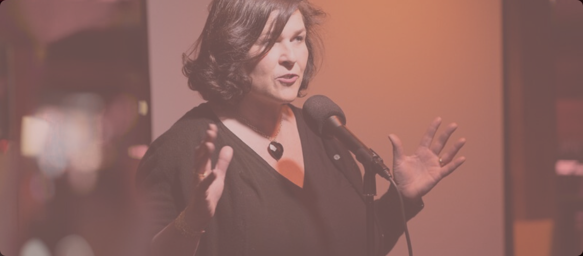 Elaine speaking banner with pinky overlay.png