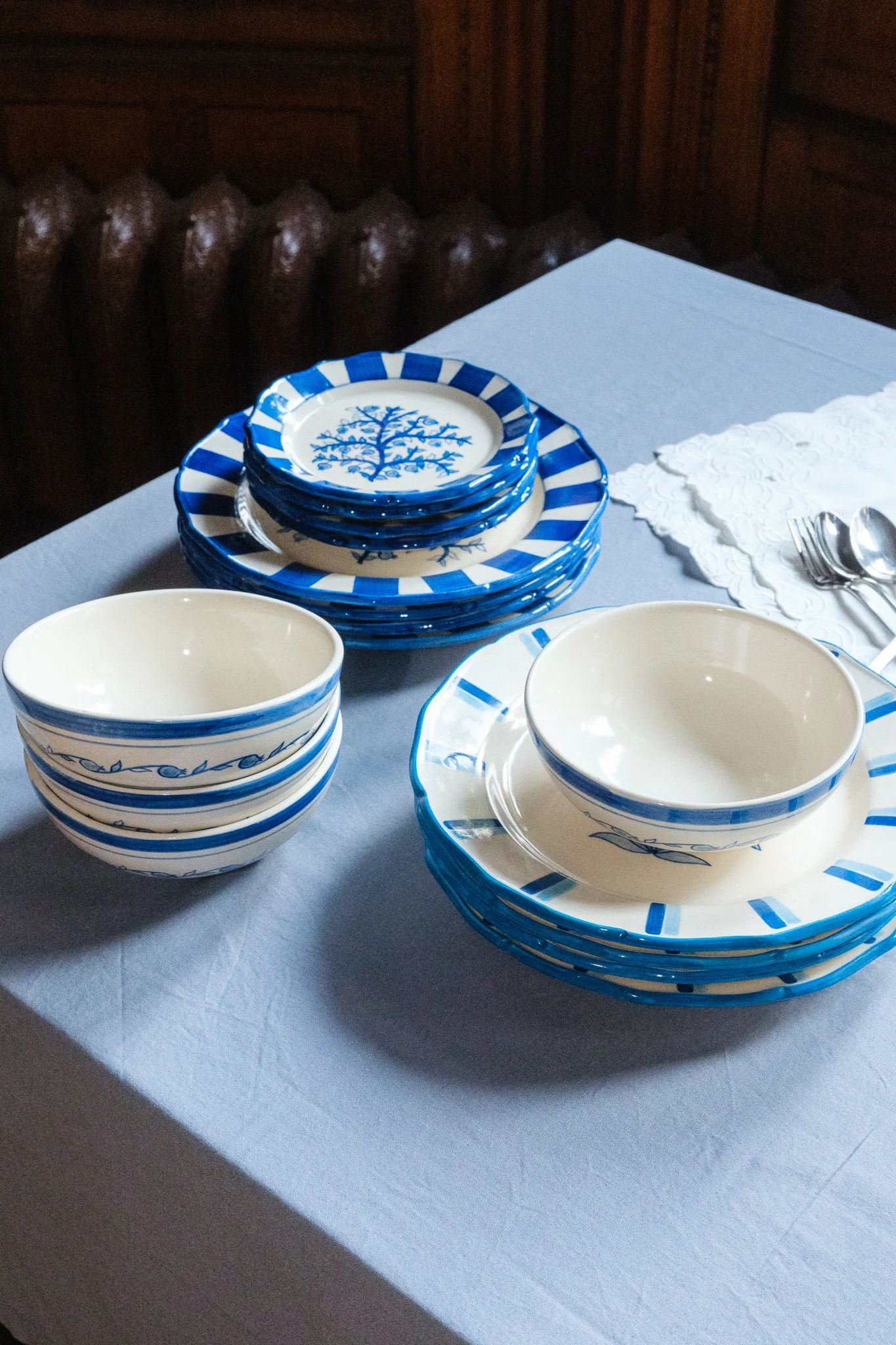 STUDIO PURANI Pomegranate breakfast bowls in blue styled with matching Pomegranate and Tulip dinnerware — hand-painted ceramic tableware collection