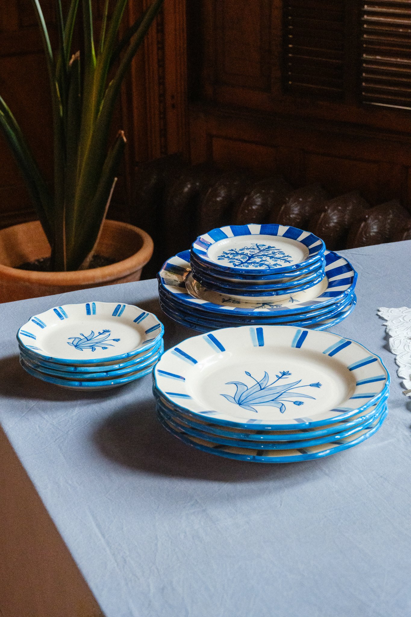 STUDIO PURANI Tulip dessert plates and dinner plates in blue stacked together — hand-painted ceramic tableware collection