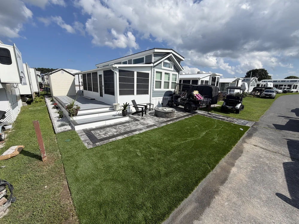 Completed outdoor living project with pavers and turf in Dagsboro Delaware