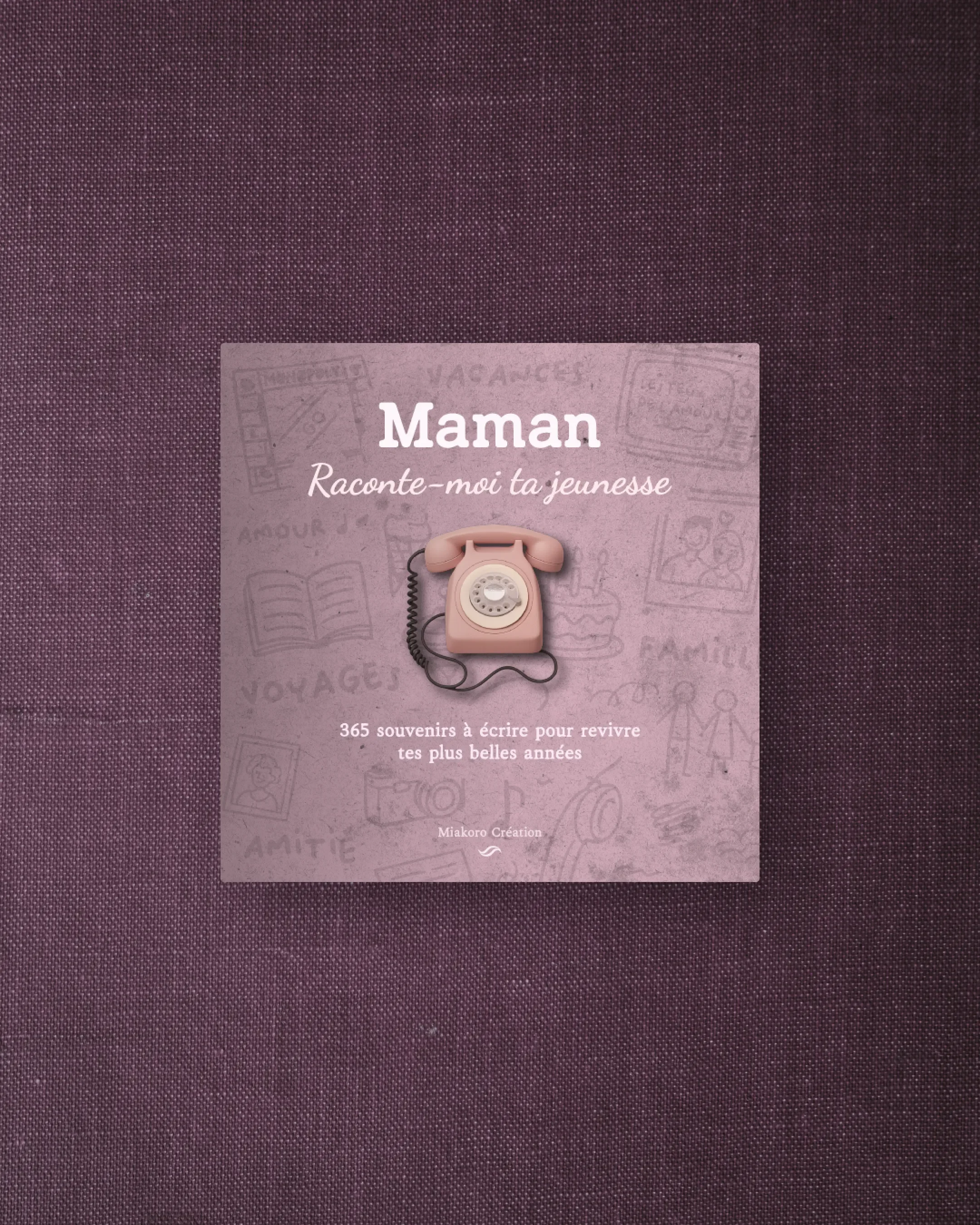 Livre avec une couverture mauve contenant un téléphone rose en plastique et du texte en français