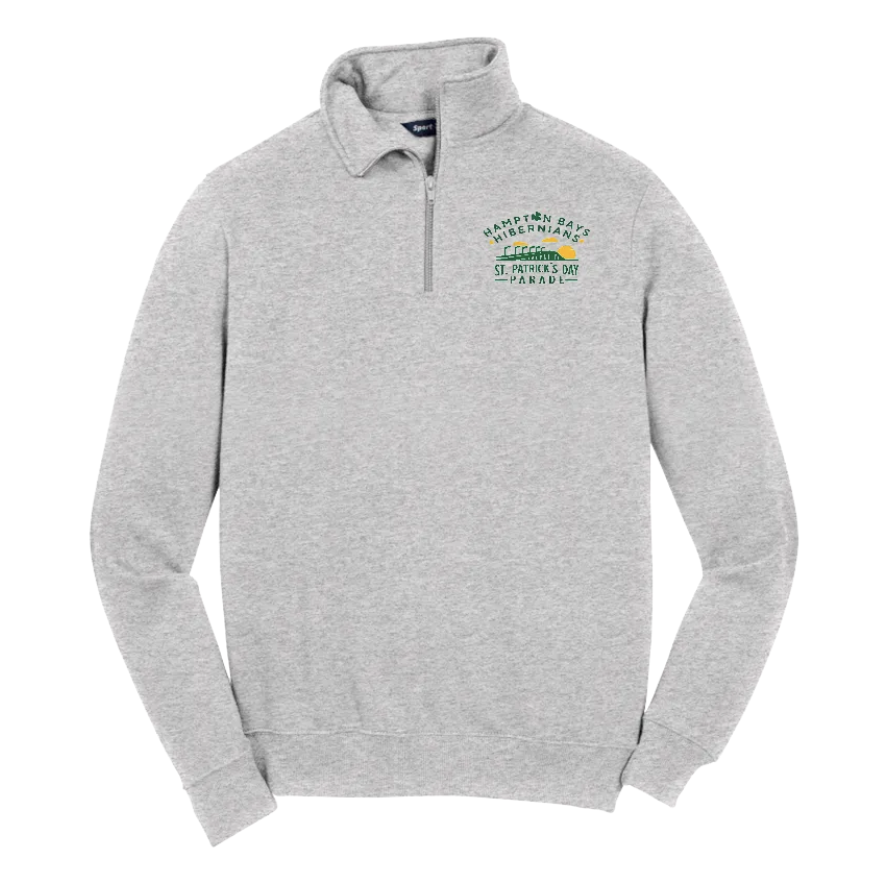 Light gray quarter-zip sweatshirt with St. Patrick's Day parade logo and shamrock graphic on the left chest.