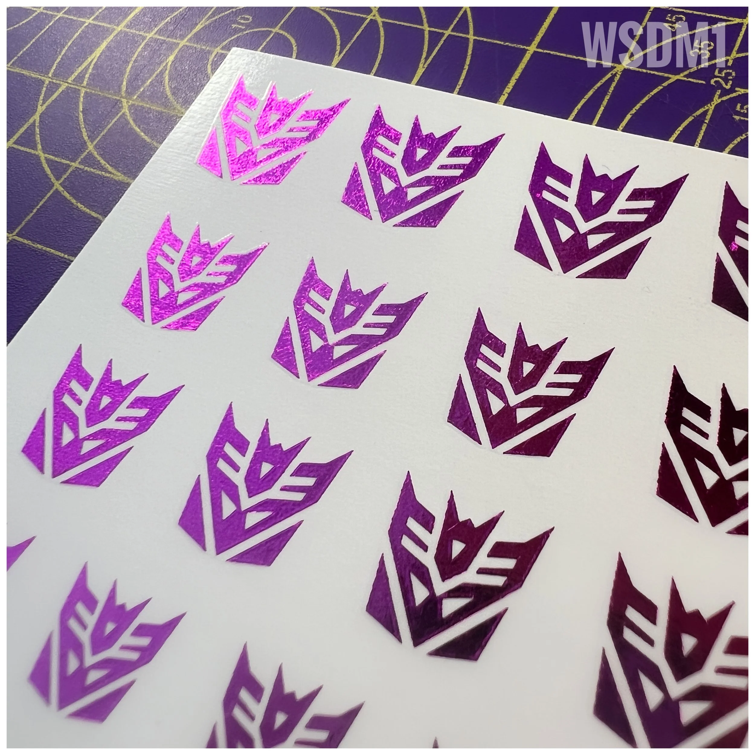 48 x Con Water Slide decals, Metallic Purple with Clear background, close up view.