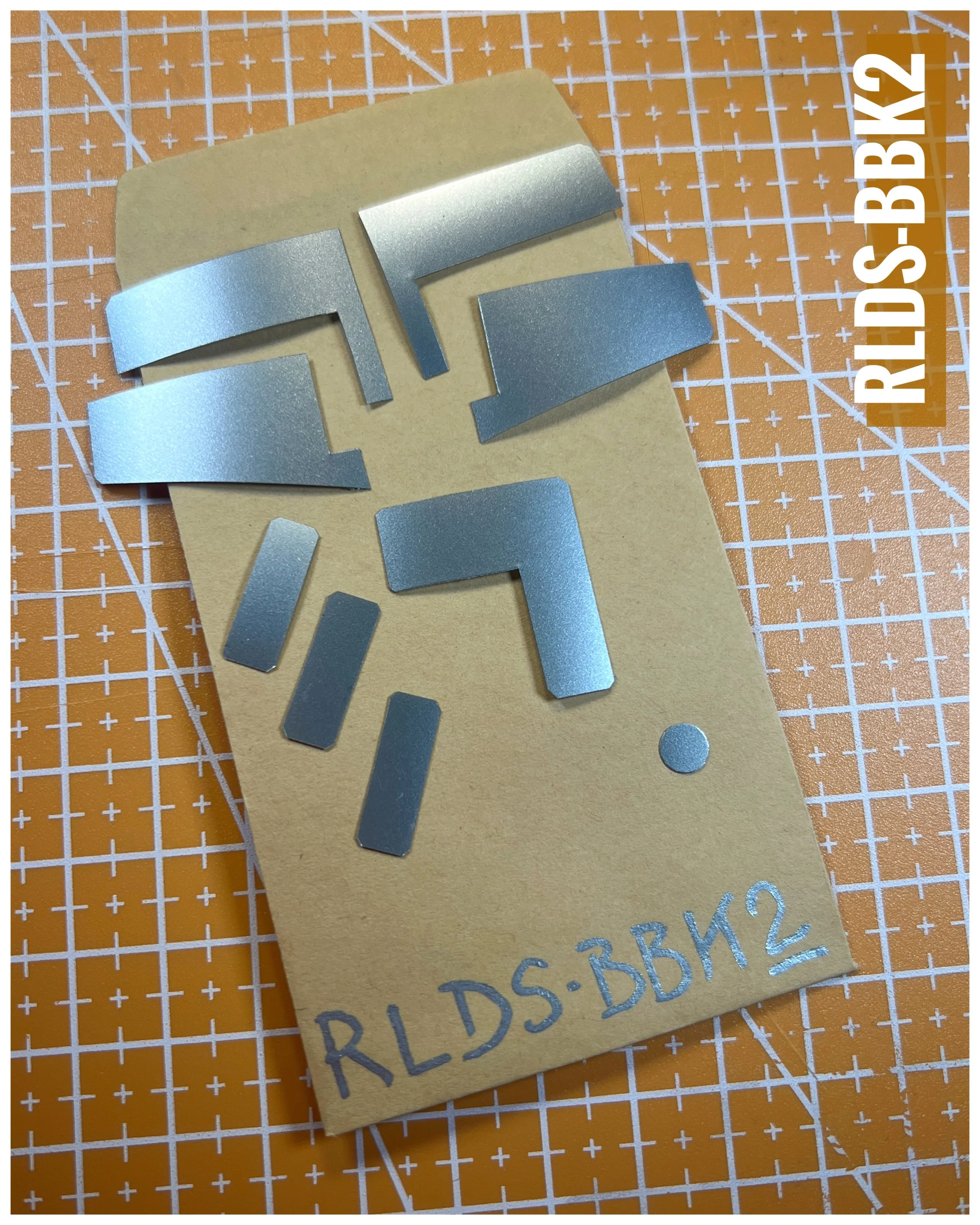 The RLDS-BBK2 sticker kit includes 9 stickers, made of metallic silver vinyl, hand cut to the correct shape to cover details on the grey waist area of the toy style leg set.