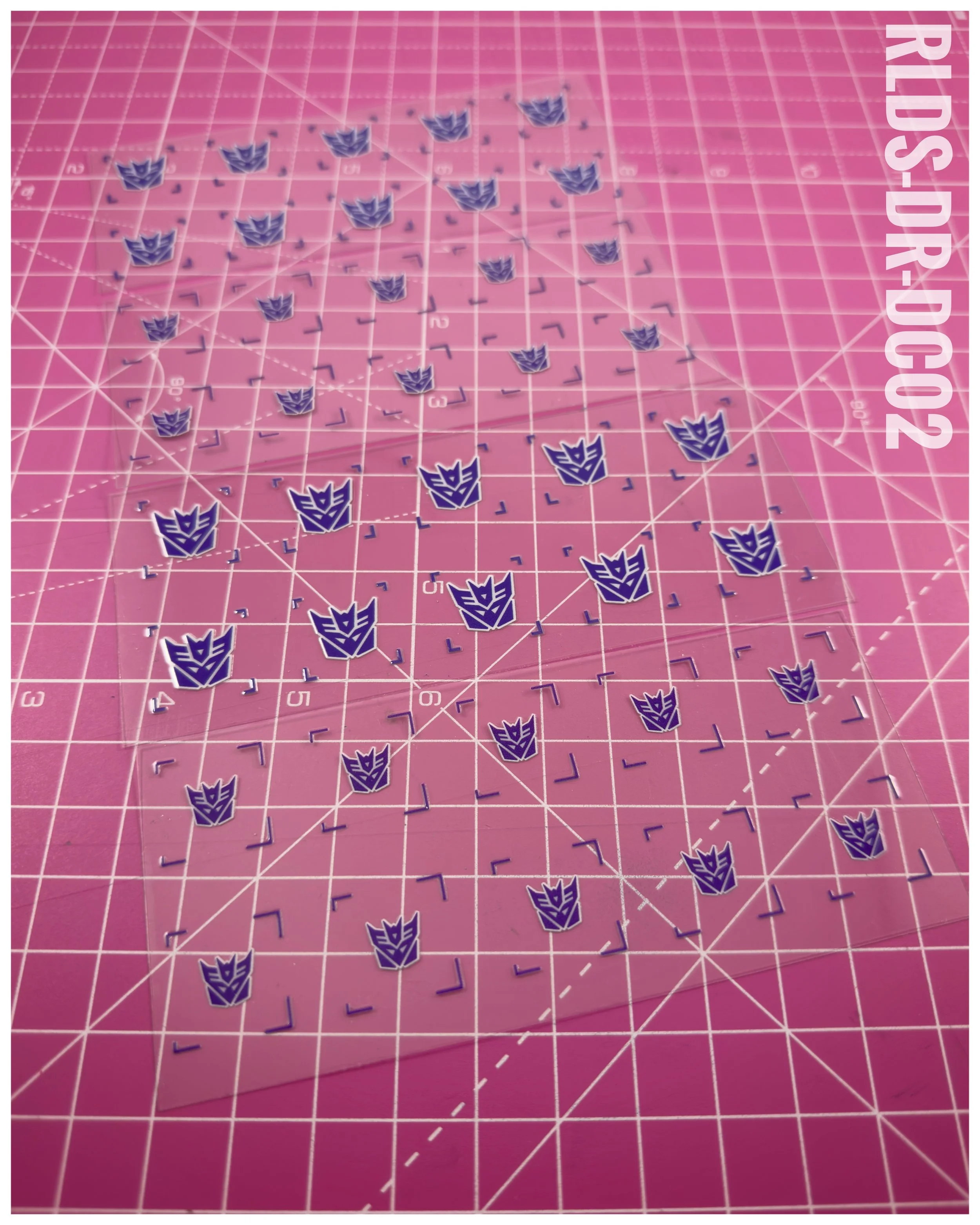 40 x Con UV DTF dry rub transfers, Toon Style, Purple with White background.