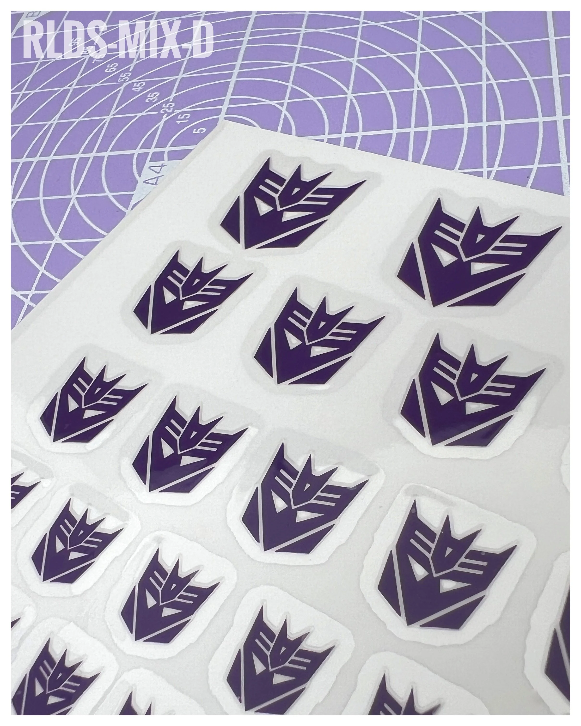 94 x Con dry rub transfers, including 12 x split logos, Purple with Clear background