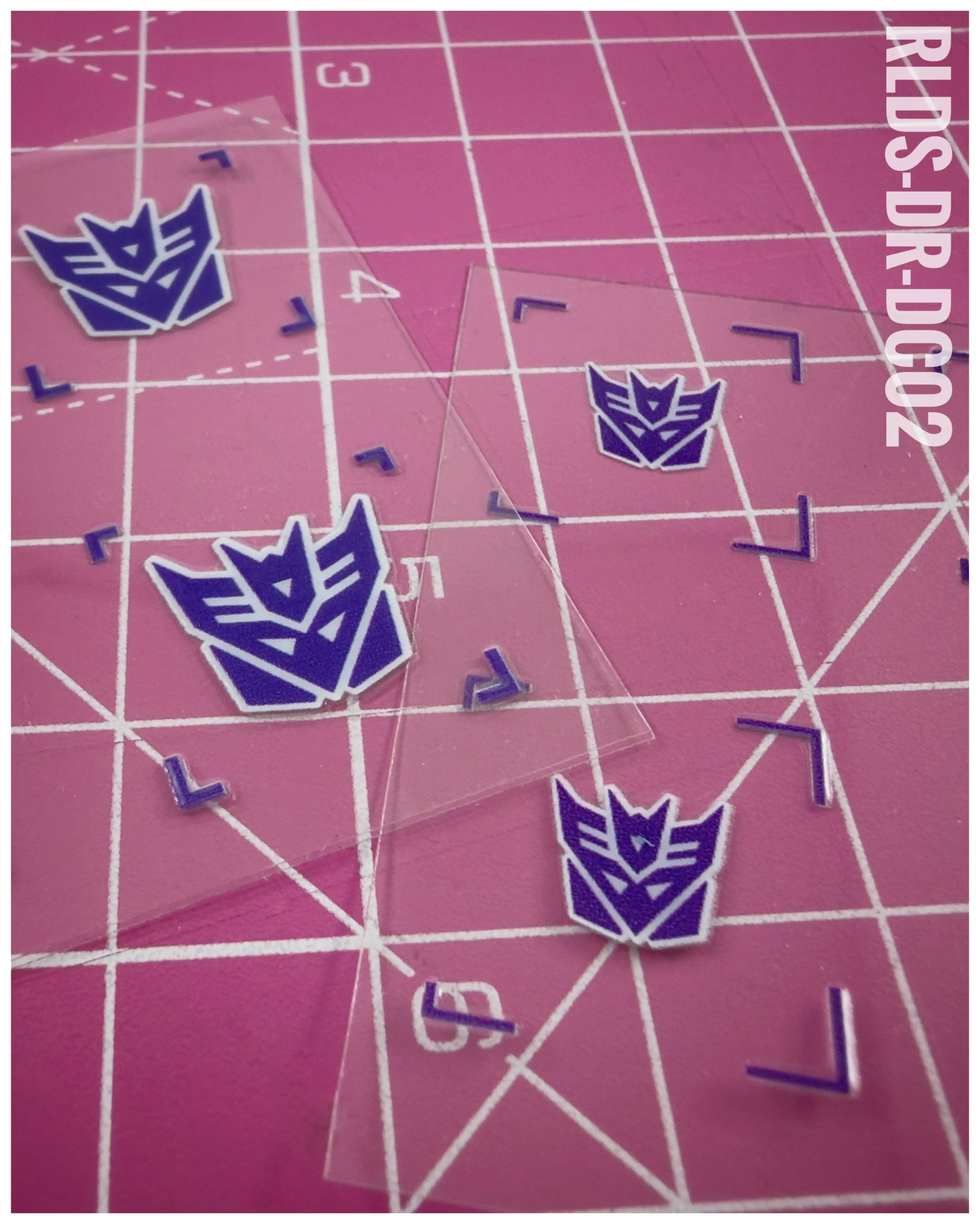 40 x Con UV DTF dry rub transfers, Toon Style, Purple with White background.