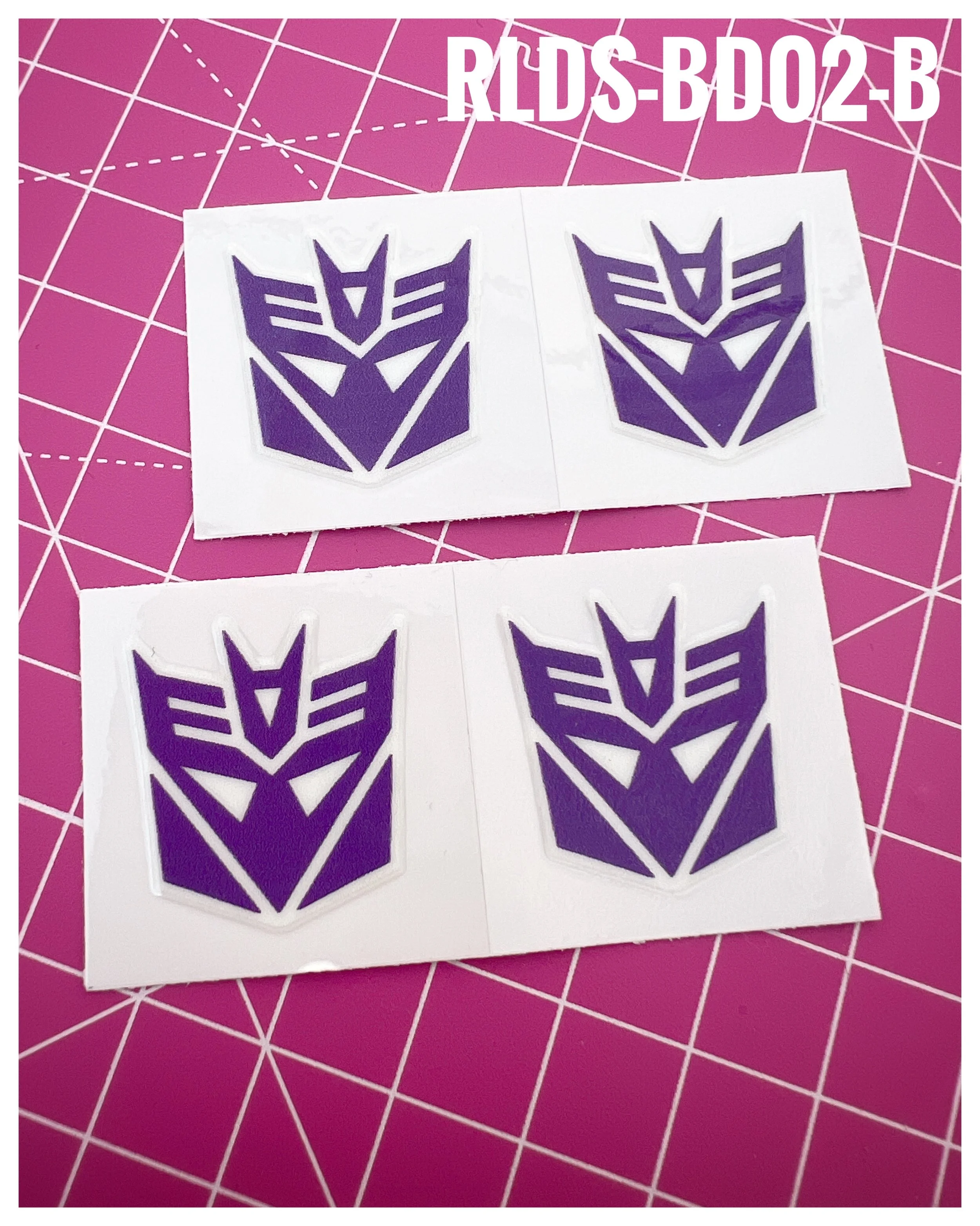 4 x large Con dry rub transfers, Toy style, Purple with White background.