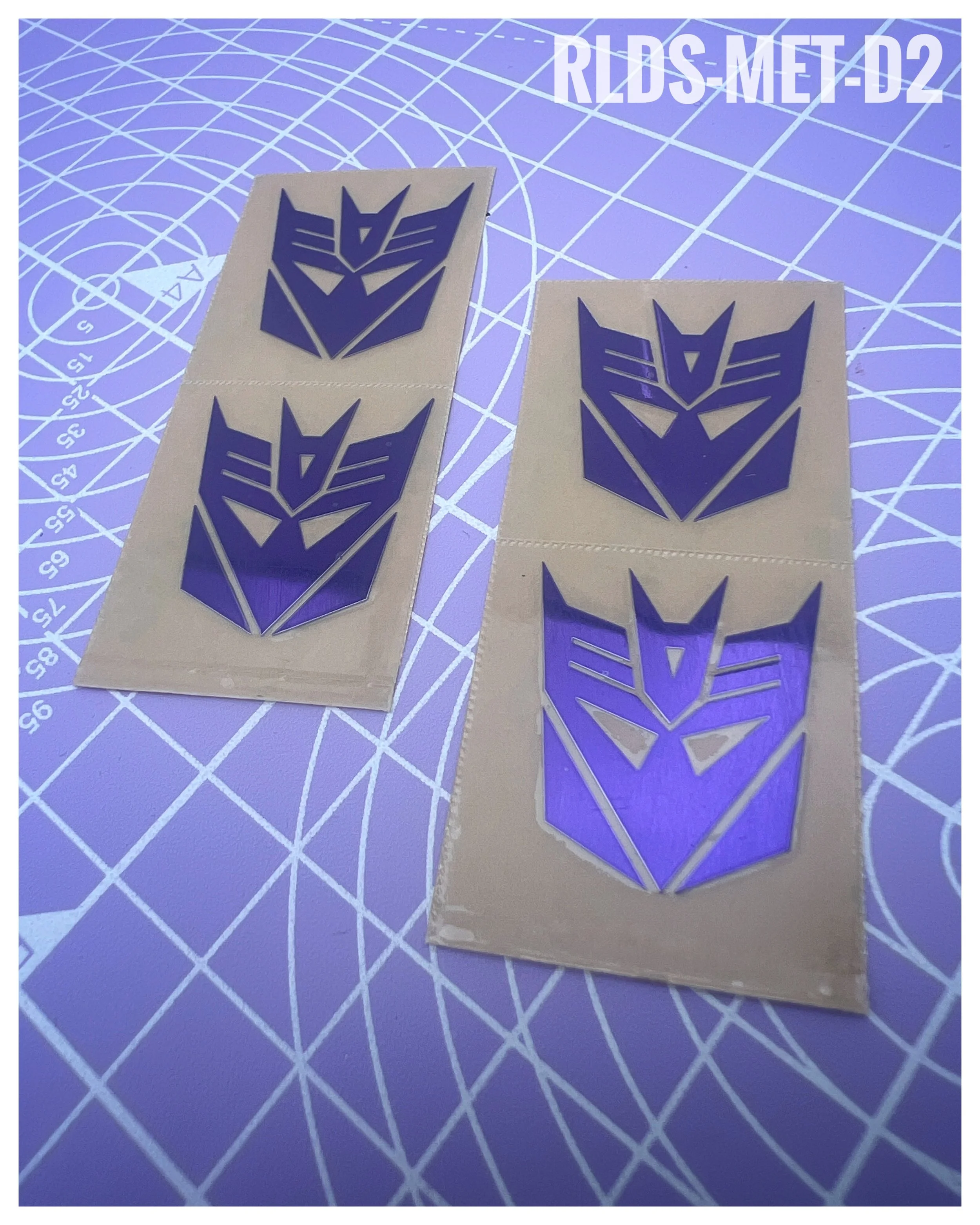 4 x large Metallic Con dry rub transfers, Toy style, Metallic Purple with Clear background.