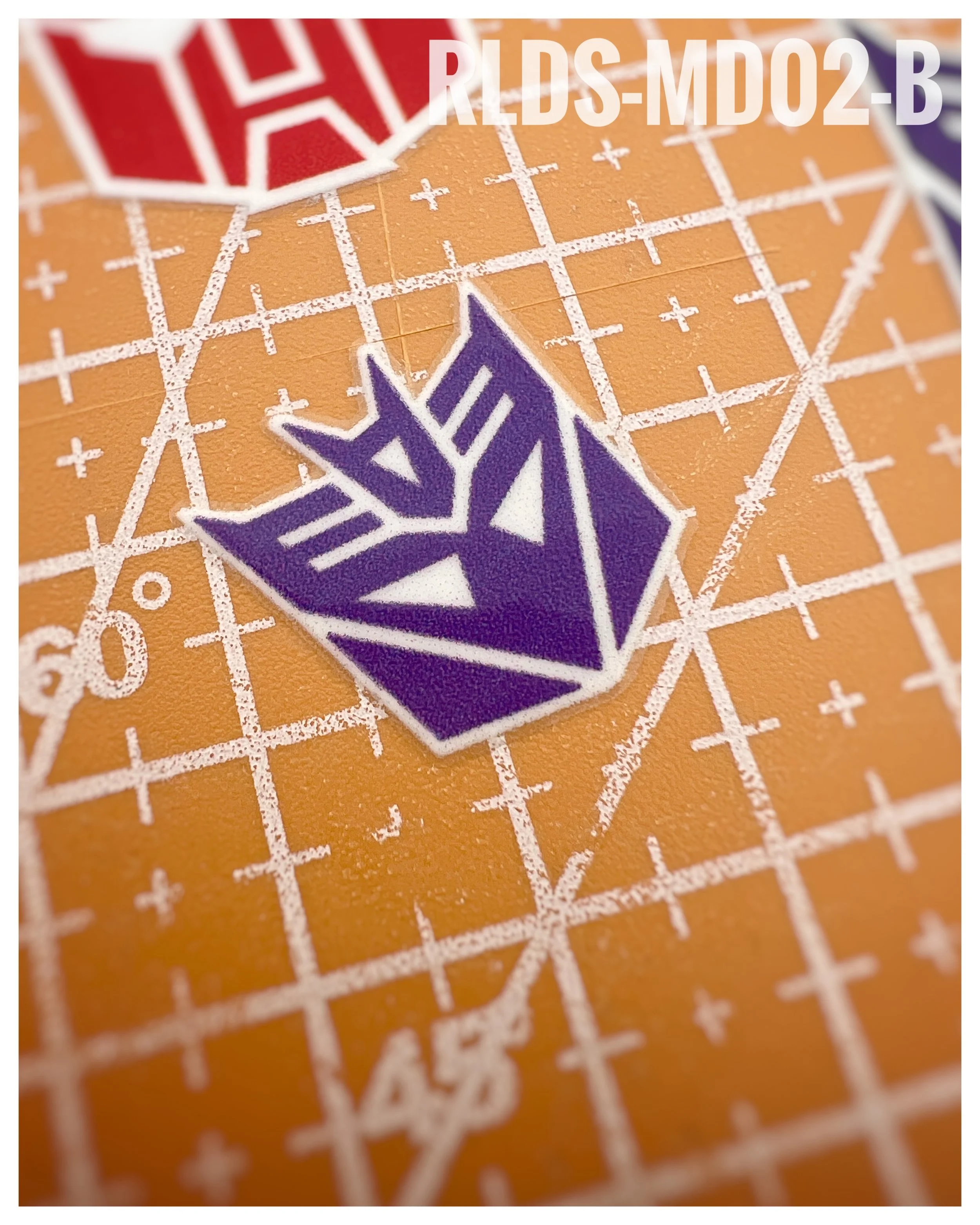 6 x medium toy style Con dry rub transfers, Purple with White background.