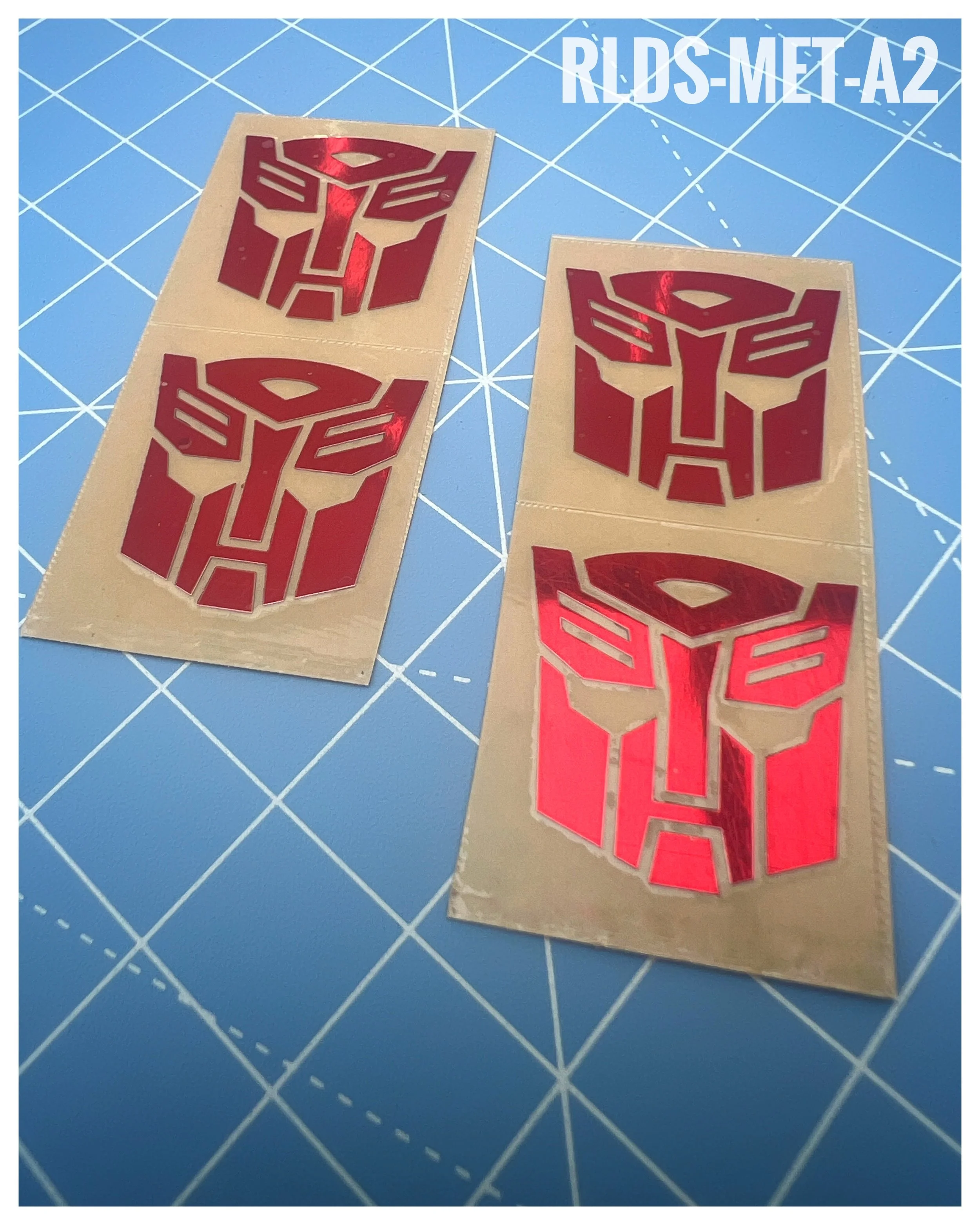 4 x large Metallic Bot dry rub transfers, Toy style, Metallic Red with Clear background.