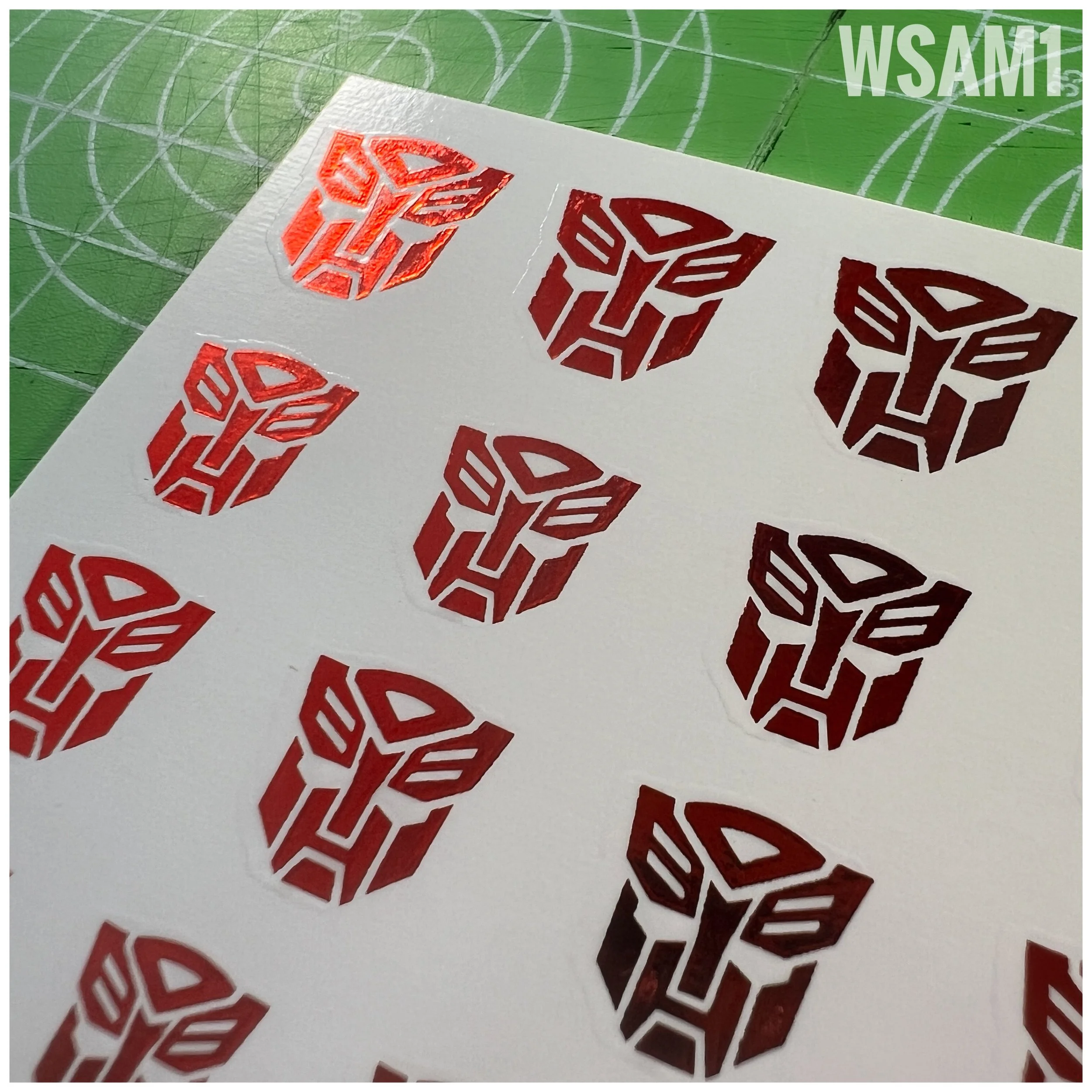 48 x Bot Water Slide decals, Metallic Red with Clear background - close up view.