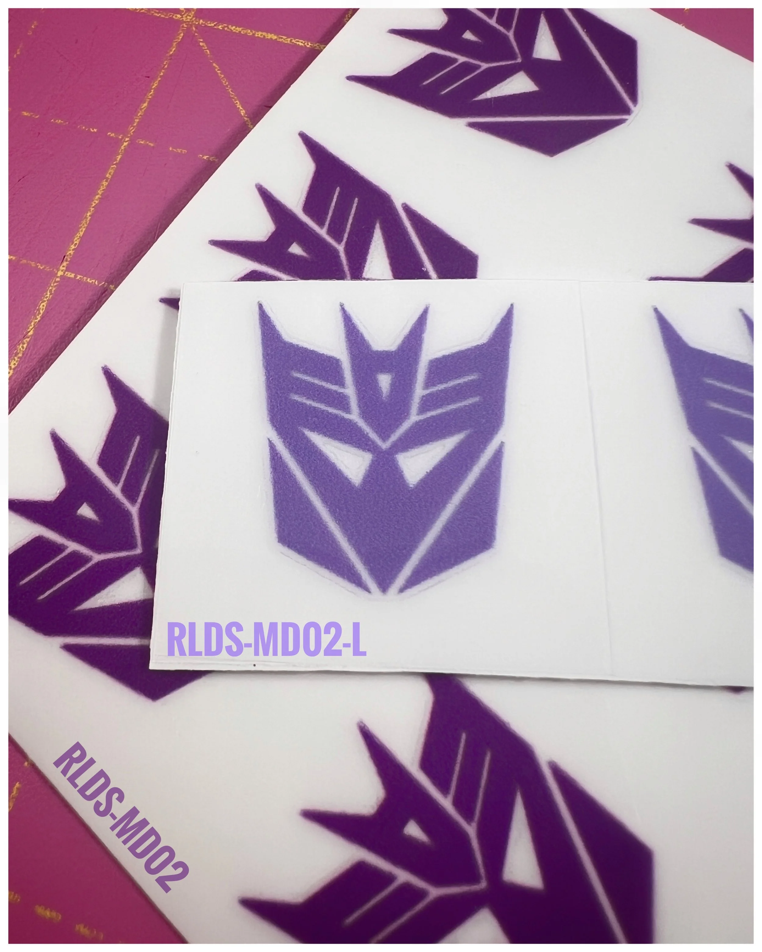 6 x medium toy style Con dry rub transfers, Light Purple with Clear background.