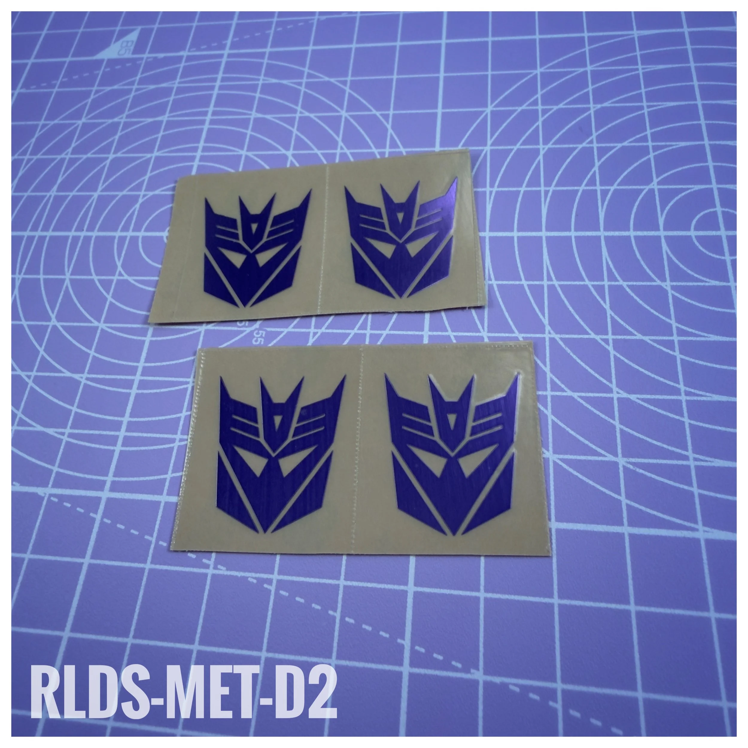 RLDS-MET-D2 - Oversize Metallic Con logos, Purple on Clear