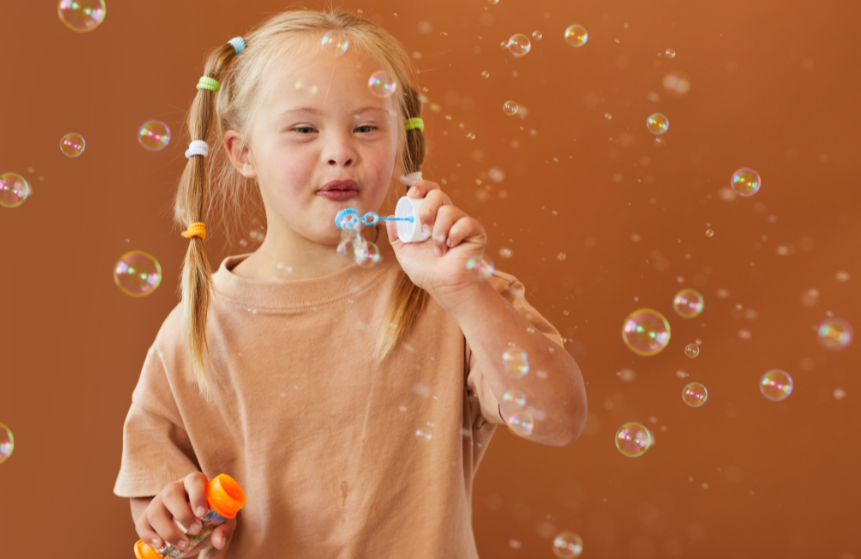 Child with Down syndrome blowing bubbles