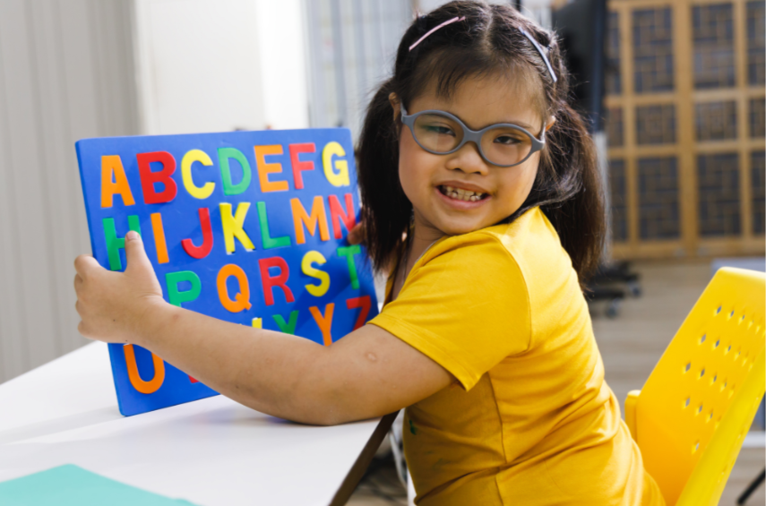 young child with Down syndrome learning letter sounds