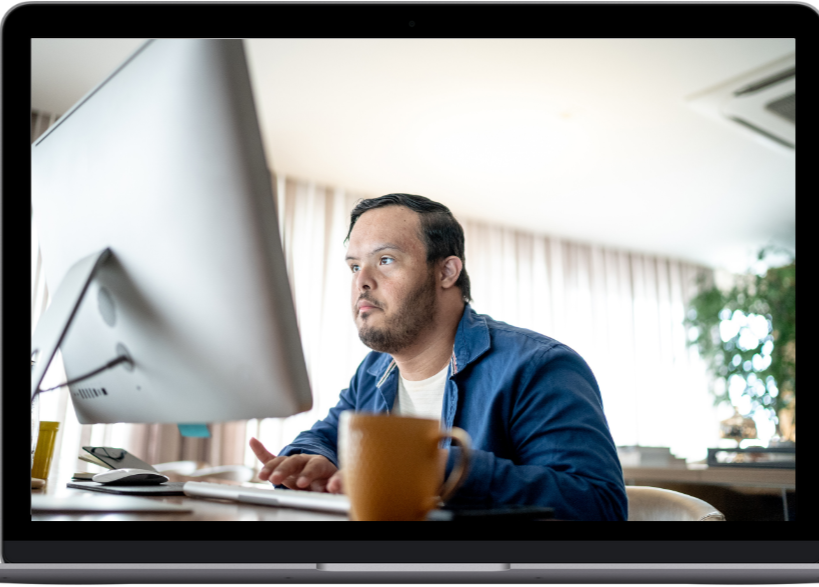 Adult with Down syndrome at a computer
