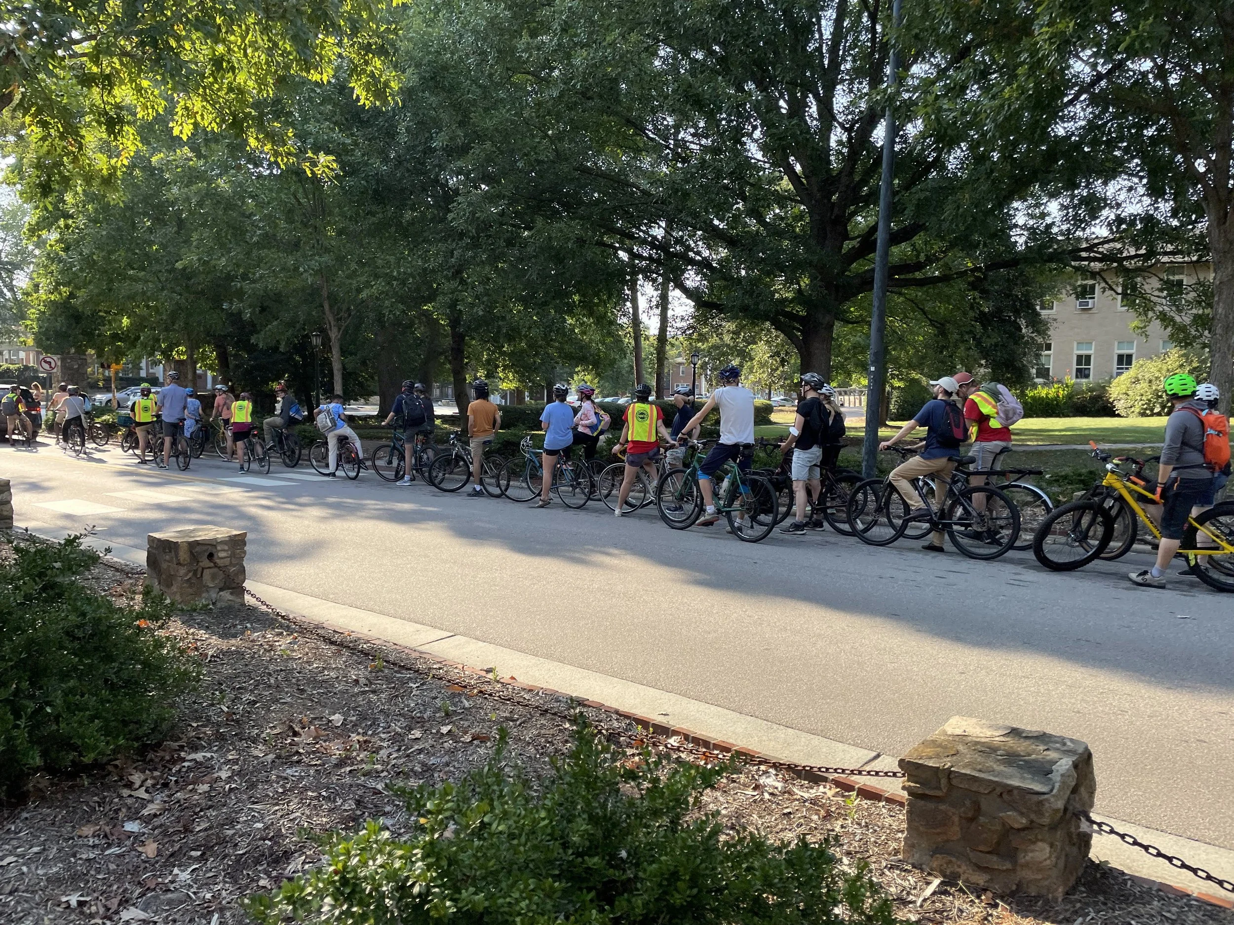photo of many people on a group bike ride on UNC campus in the summer