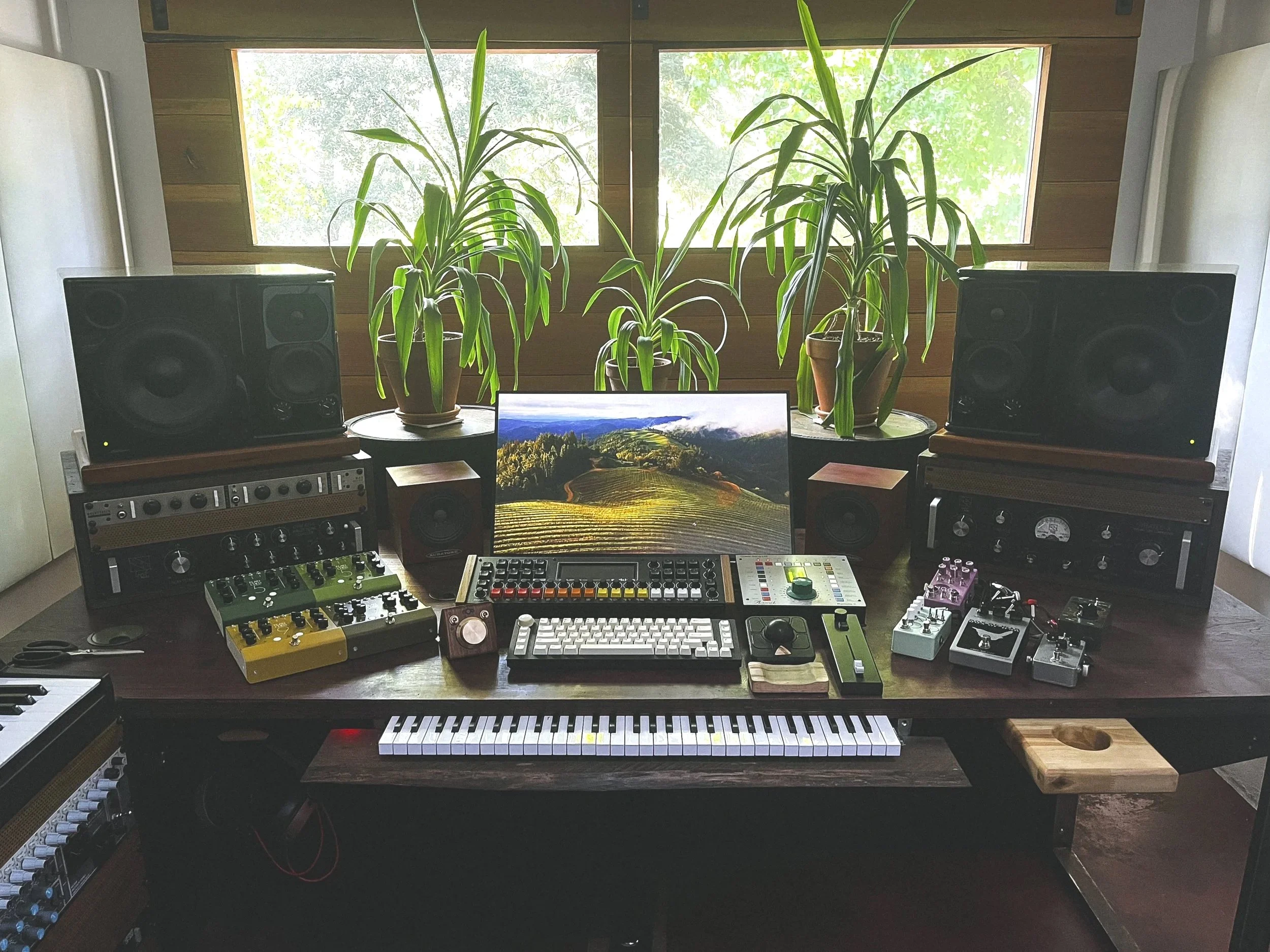 FADE on a studio desk next to a lot of other gear, showcasing its small footprint