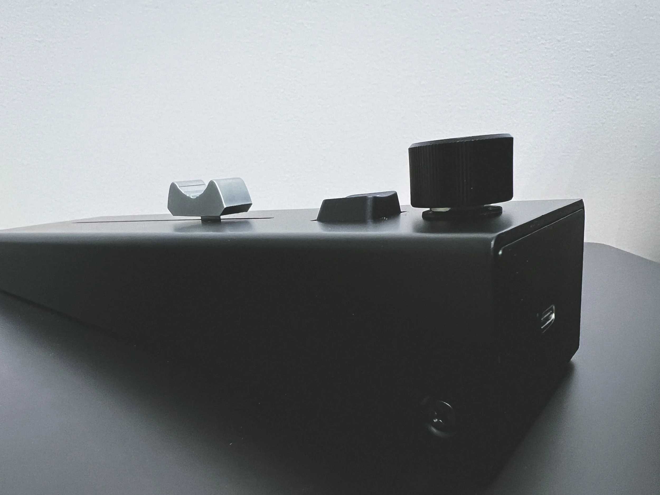 Side view of FADE, showcasing the fader, button, and encoder