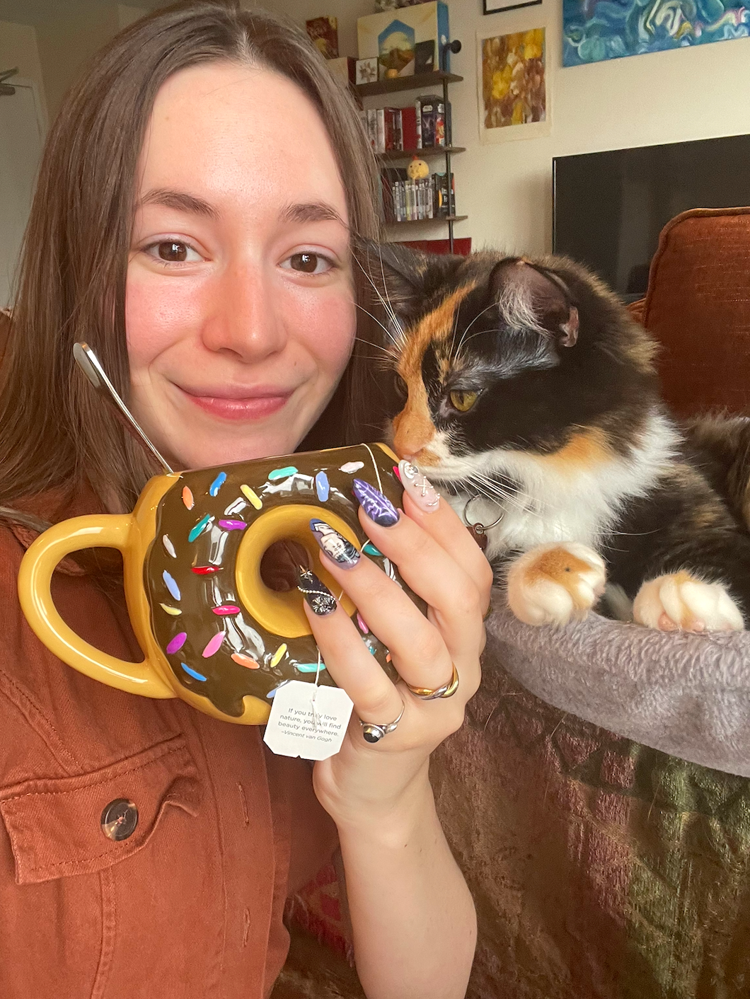Sophie Conklin with a cat, and a tea cup.