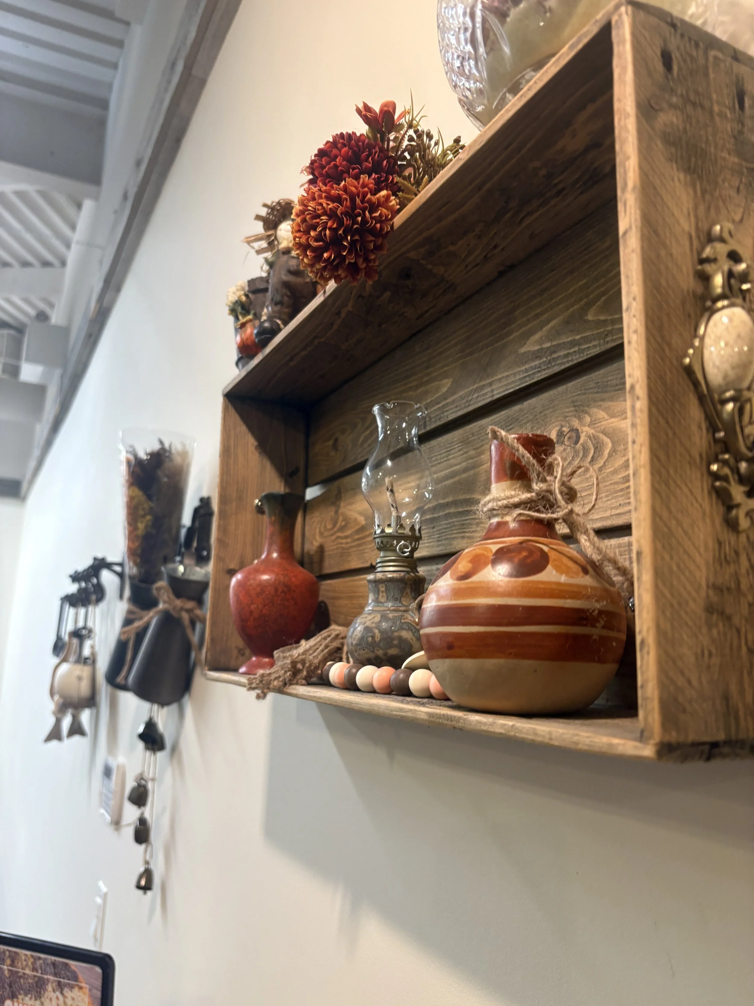 Traditional Middle Eastern decor displayed on rustic wooden wall shelf inside Solomon’s Oven, a warm and inviting halal bakery in Ottawa.