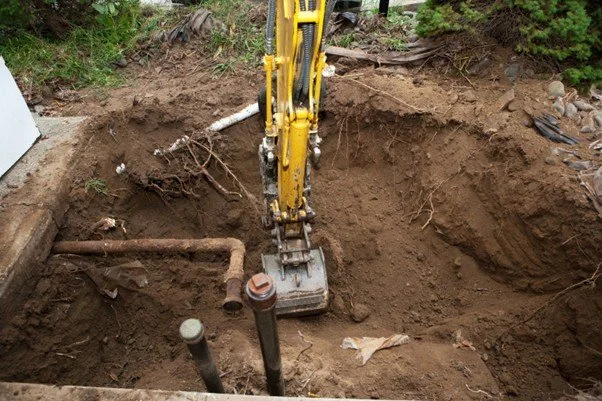 Excavator exposing a subsurface area during an underground storage tank investigation in Idaho