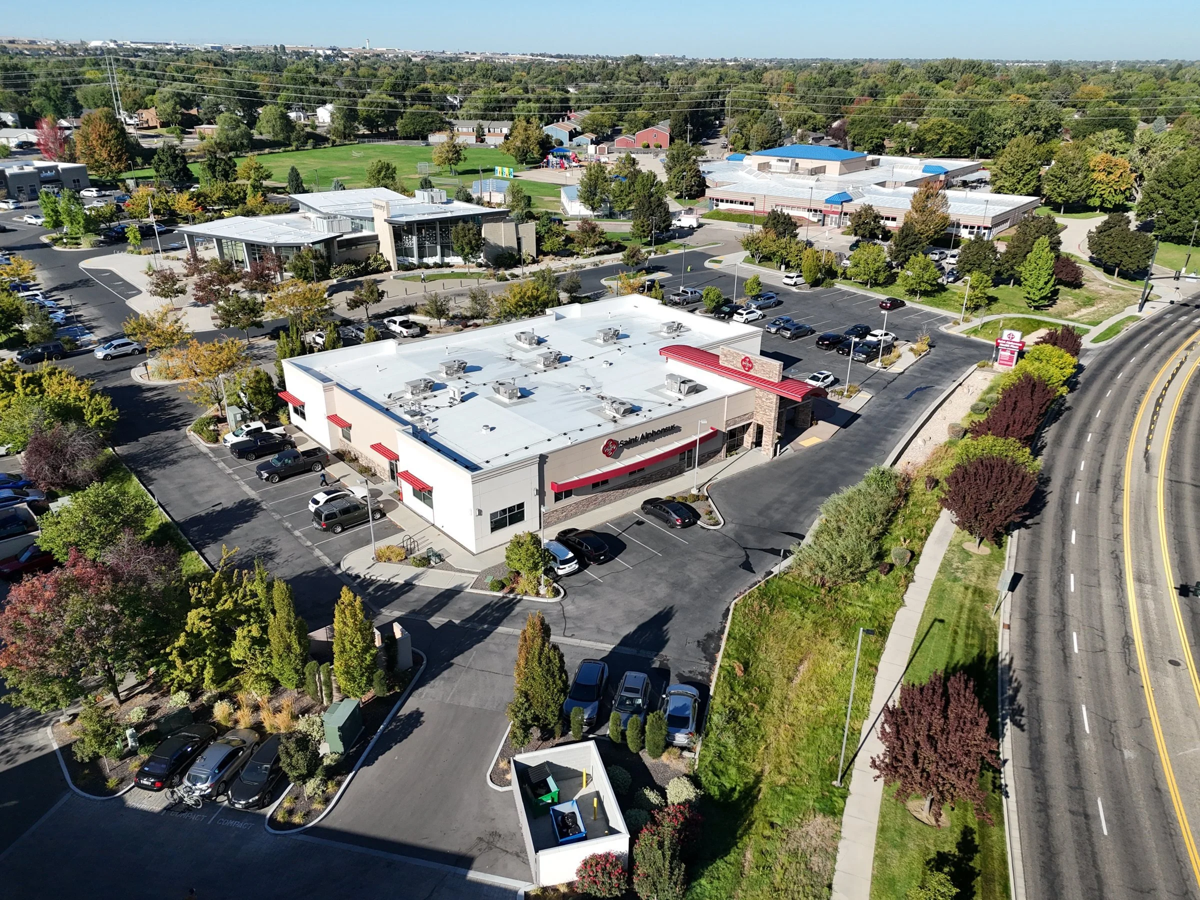 Drone view of a medical clinic and surrounding commercial properties