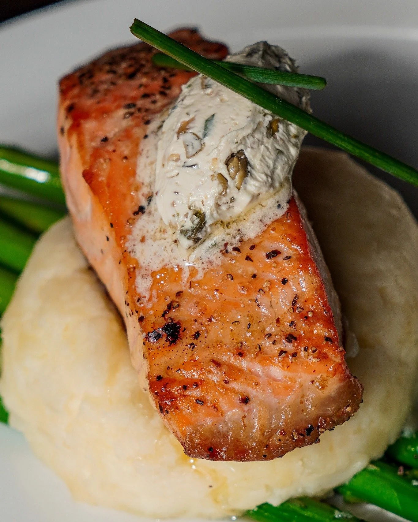 A forkful of comfort, a bite of brightness. 🐟🍋

Our pan-seared Scottish Salmon is served over creamy whipped potatoes, tender asparagus, and finished with a rich lemon-caper butter sauce that brings it all together.

Light, flavorful, and exactly w