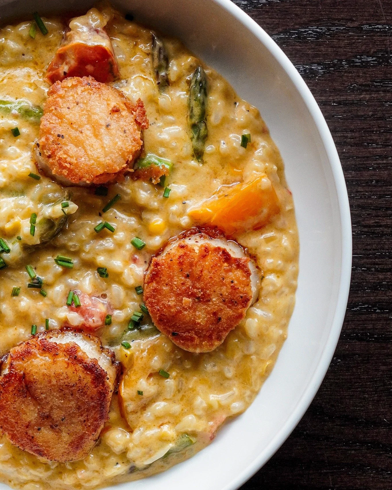 Scallops on a Wednesday? Yeah, we&rsquo;re doing that!

Pan-seared and served with parmesan risotto, asparagus, heirloom tomato, and a sweet corn emulsion that makes it all hit just right.

Grab a fork, a drink, and a seat&mdash;we&rsquo;re here till