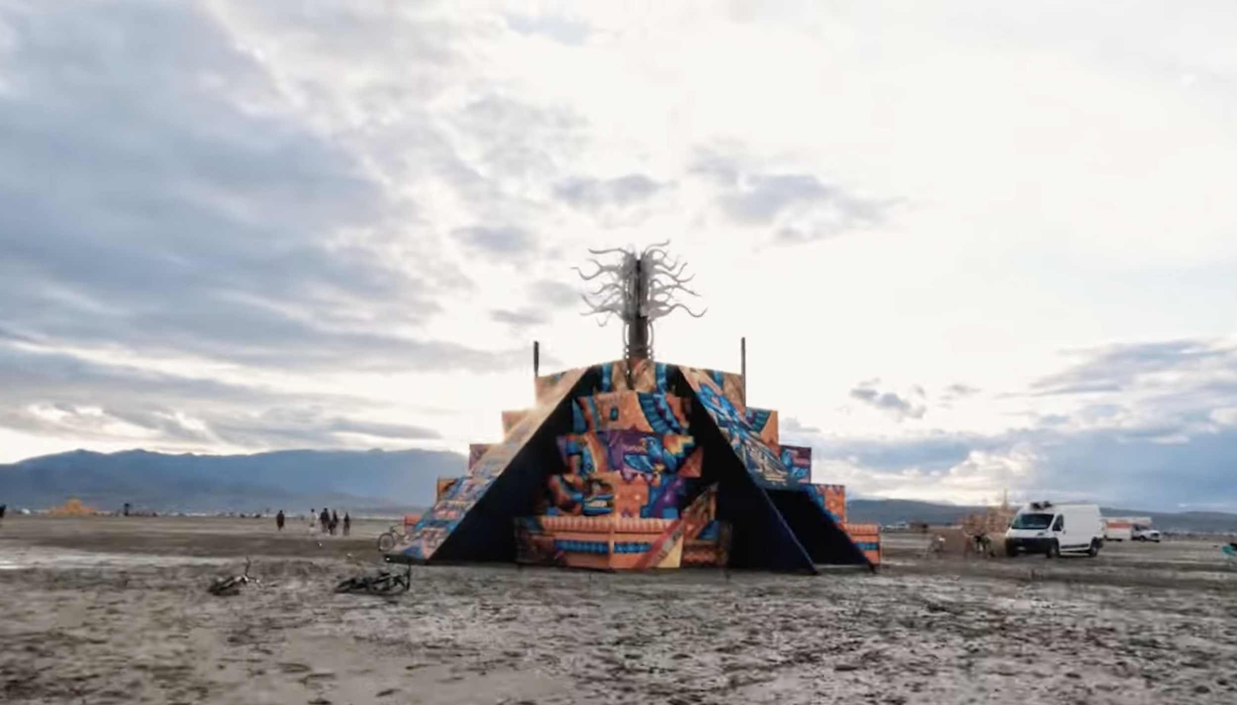 Completed pyramid temple standing in the open desert—large-scale festival architecture designed and built for rapid deployment.