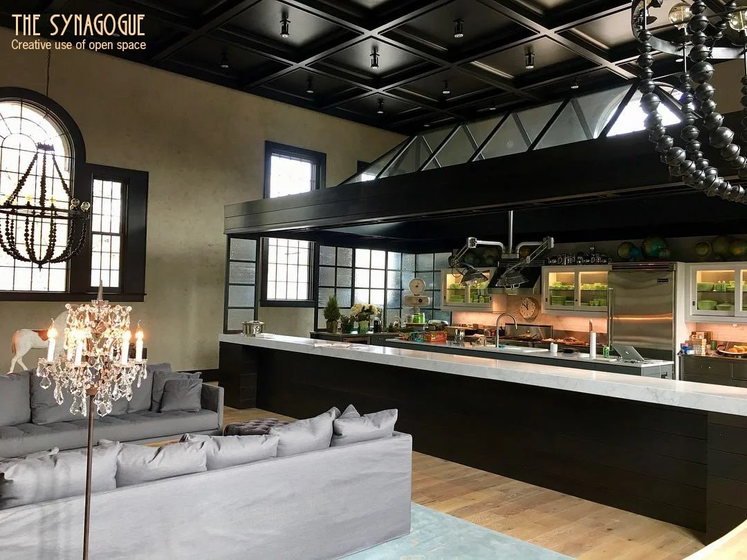 Spectacular kitchen made of steel, glass, and wood built within the main space