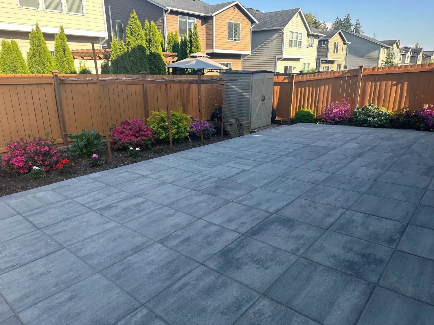 Custom concrete paver patio installation with modern gray finish at a Sammamish, WA residential backyard