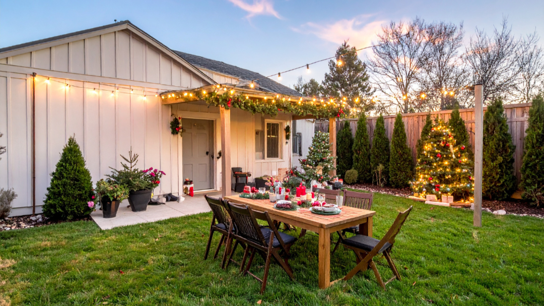 Backyard outdoor living space with covered patio, dining area, and string lights at a SeaTac, WA home