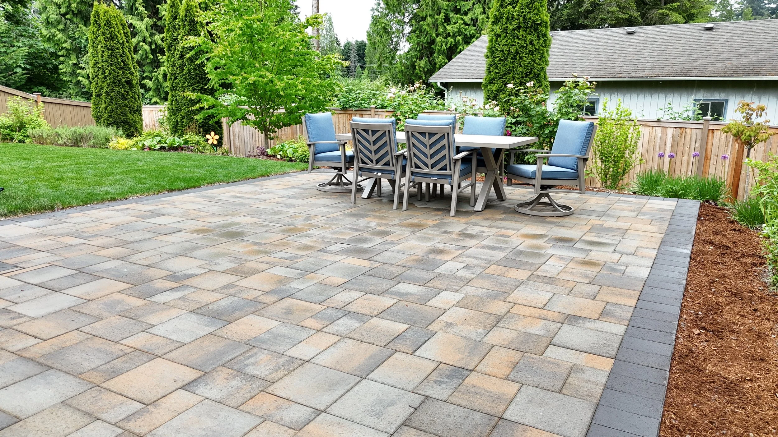 Premium concrete paver patio with tumbled finish at a Renton, WA home with outdoor dining setup