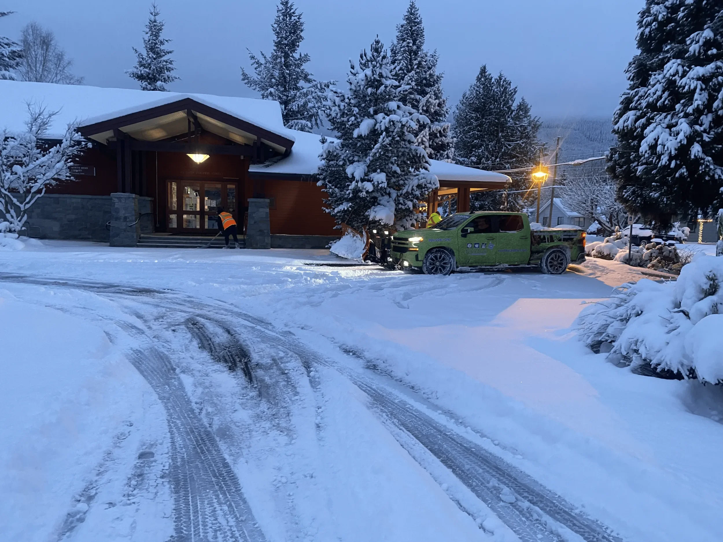 Commercial snow removal crew clearing walkways in King County, WA