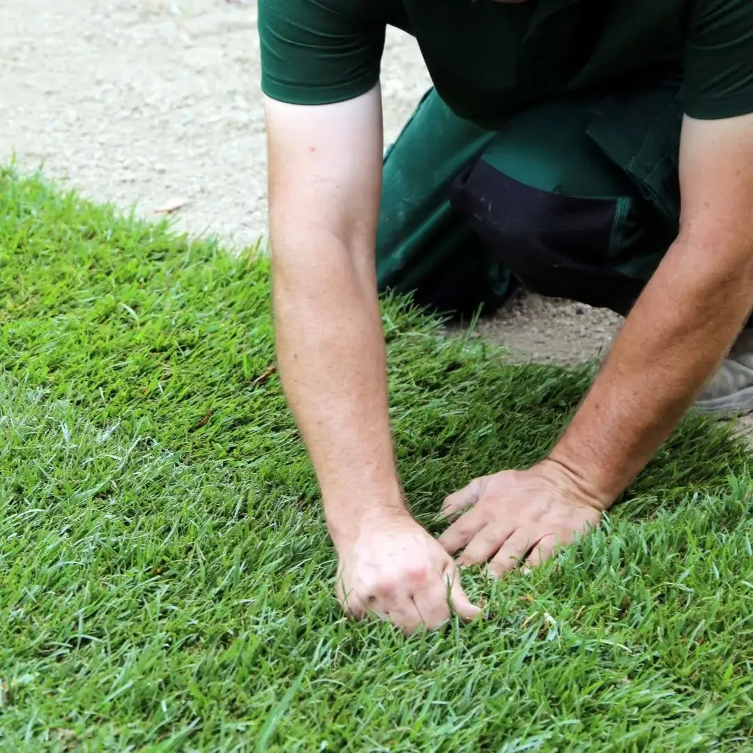 Professional installer hand-finishing artificial turf seams during a Seattle, WA installation