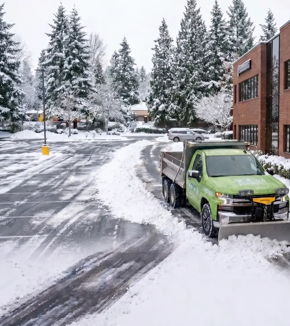North East Landscaping snow plow truck and crew clearing the Northshore Business Center on Bothell-Everett Highway in Bothell, WA