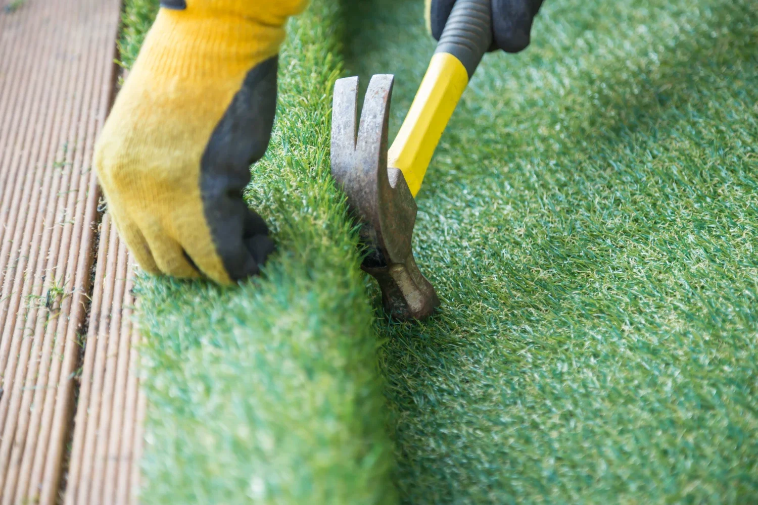 Professional artificial turf installation in Kirkland, WA showing precise seam-joining work